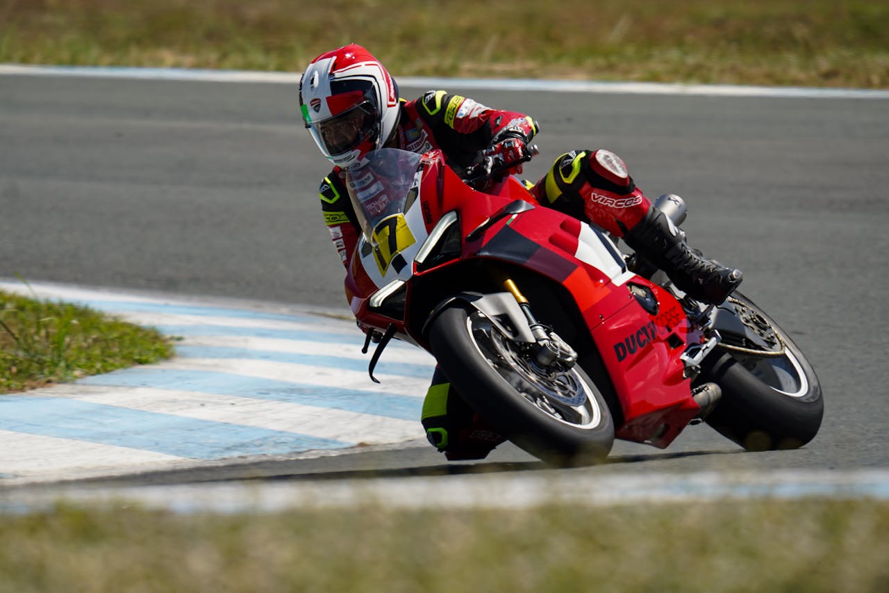 services-03 Motorcycle racer leaning into a fast turn on a race track in Central Luzon, Philippines.